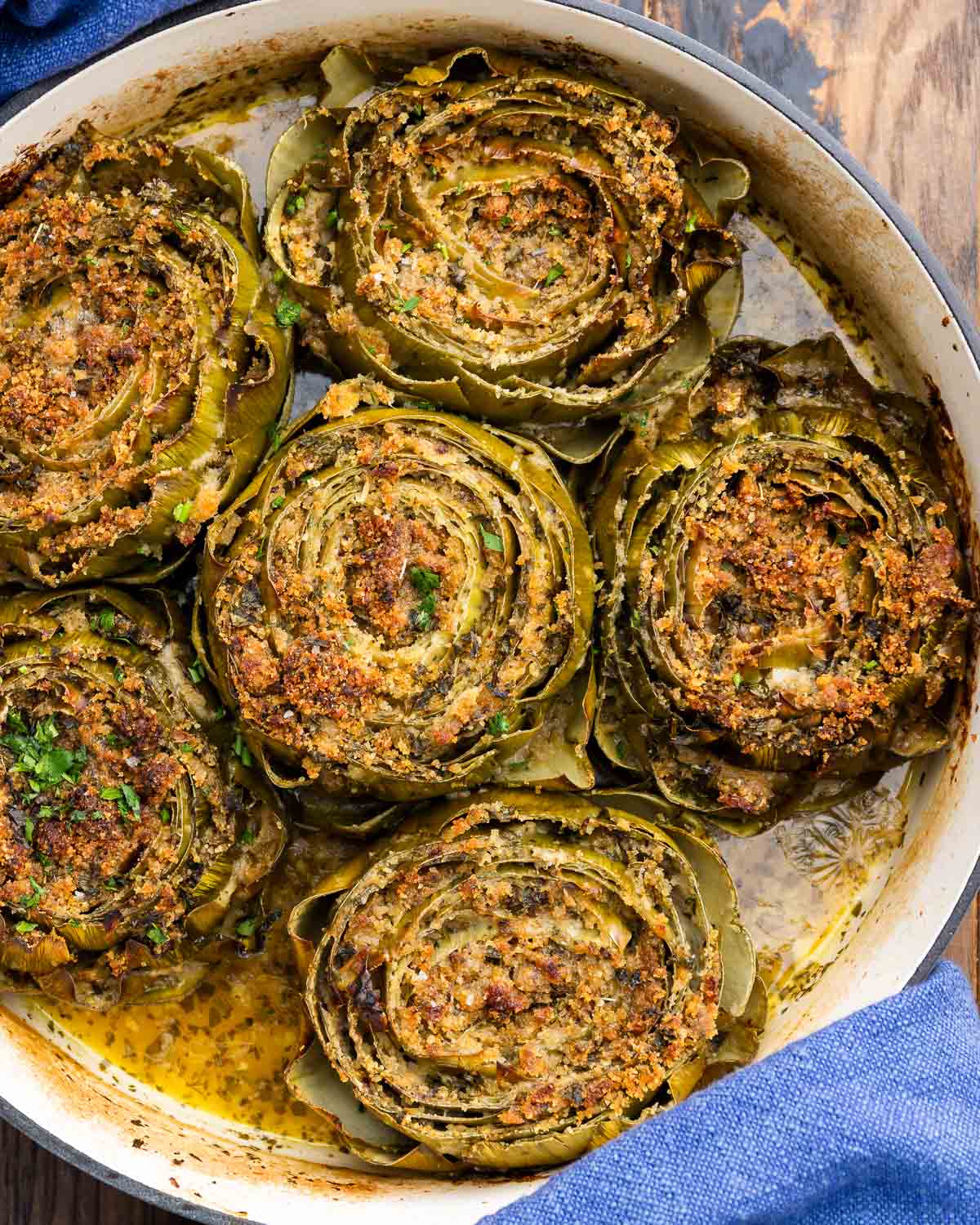 Dutch oven with baked stuffed artichokes.