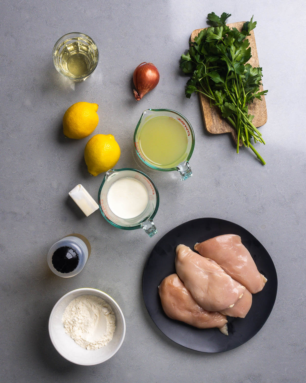 Ingredients shown: white wine, shallot, parsley, lemons, chicken stock, butter, heavy cream, olive oil, flour, and chicken breasts.