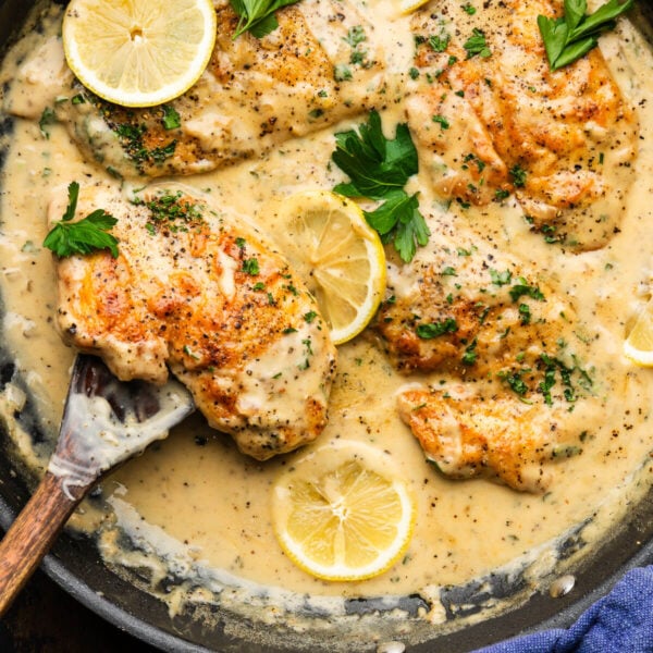 Lemon pepper chicken in black pan.
