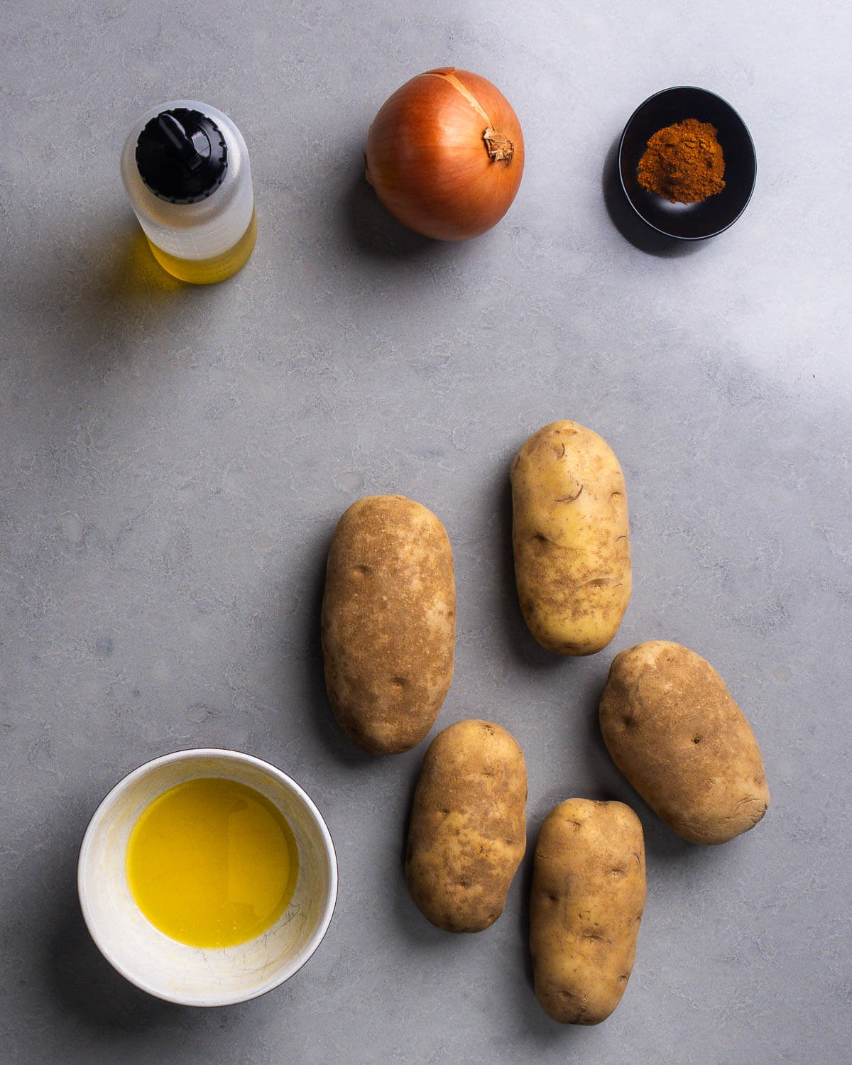 Ingredients shown: neutral oil, onion, paprika, ghee, and russet potatoes.