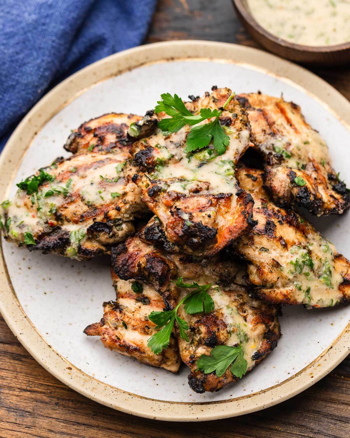 Small plate with Italian grilled chicken thighs.