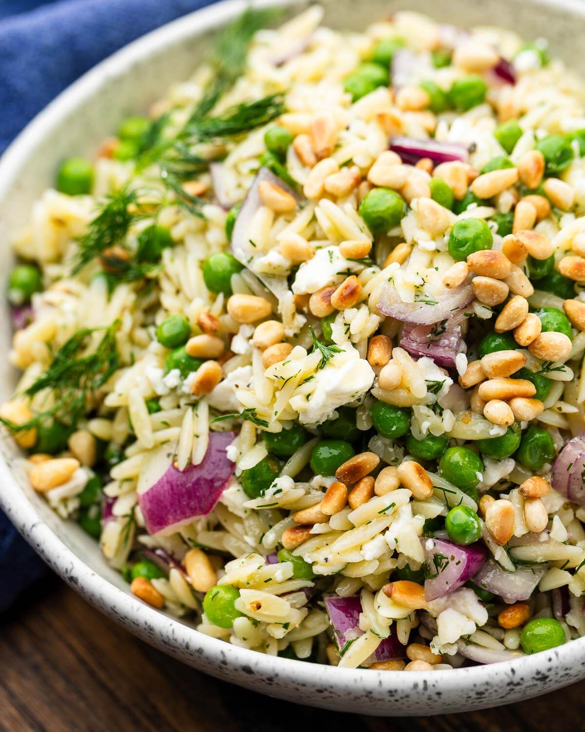 White bowl with lemon herb orzo salad.