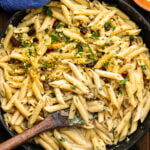 Large black pan with pistachio pasta.