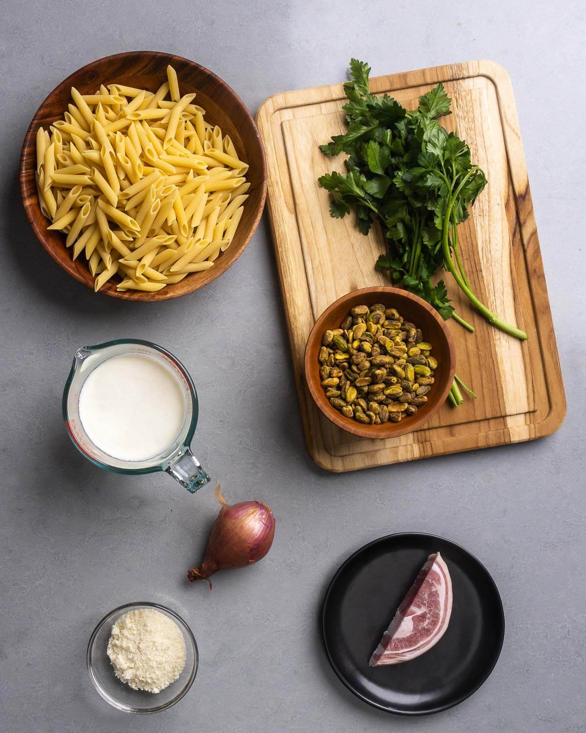 Ingredients shown: penne pasta, pistachios, parsley, heavy cream, shallot, parmesan cheese, and pancetta.