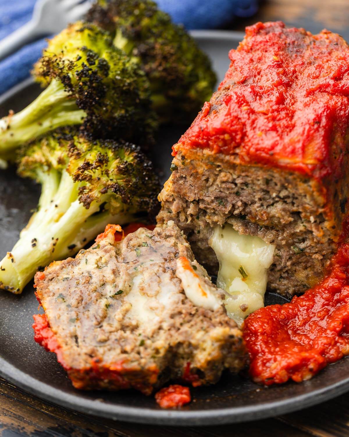 Mini stuffed meatloaf on plate with roasted broccoli.