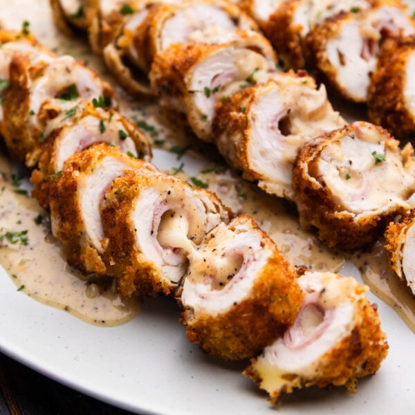 Slices of chicken cordon bleu with cheese and ham showing.