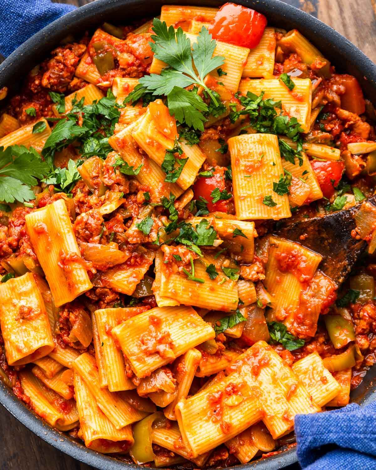 Large black pan with spicy chorizo pasta.