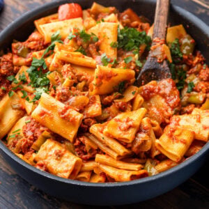 Pan with chorizo pasta topped with parsley garnish.