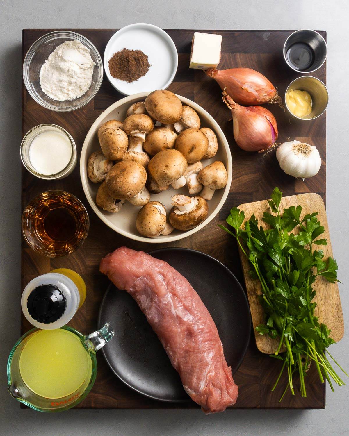 Ingredients shown: flour, allspice, butter, shallots, worcestershire sauce, dijon mustard, garlic, cream, mushrooms, brandy, olive oil, chicken stock, pork tenderloin, and parsley.