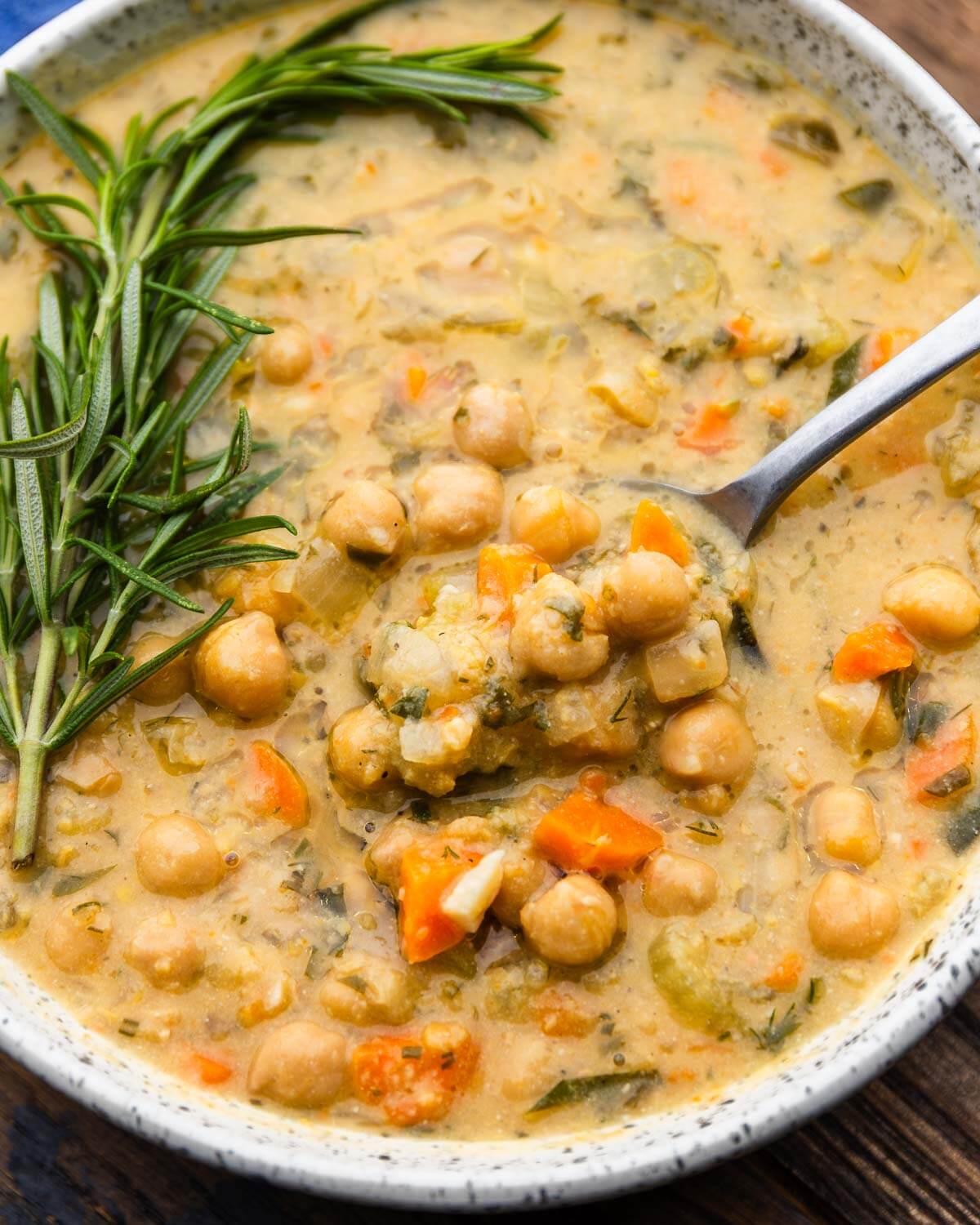 Spoon scooping out Greek chickpea soup.