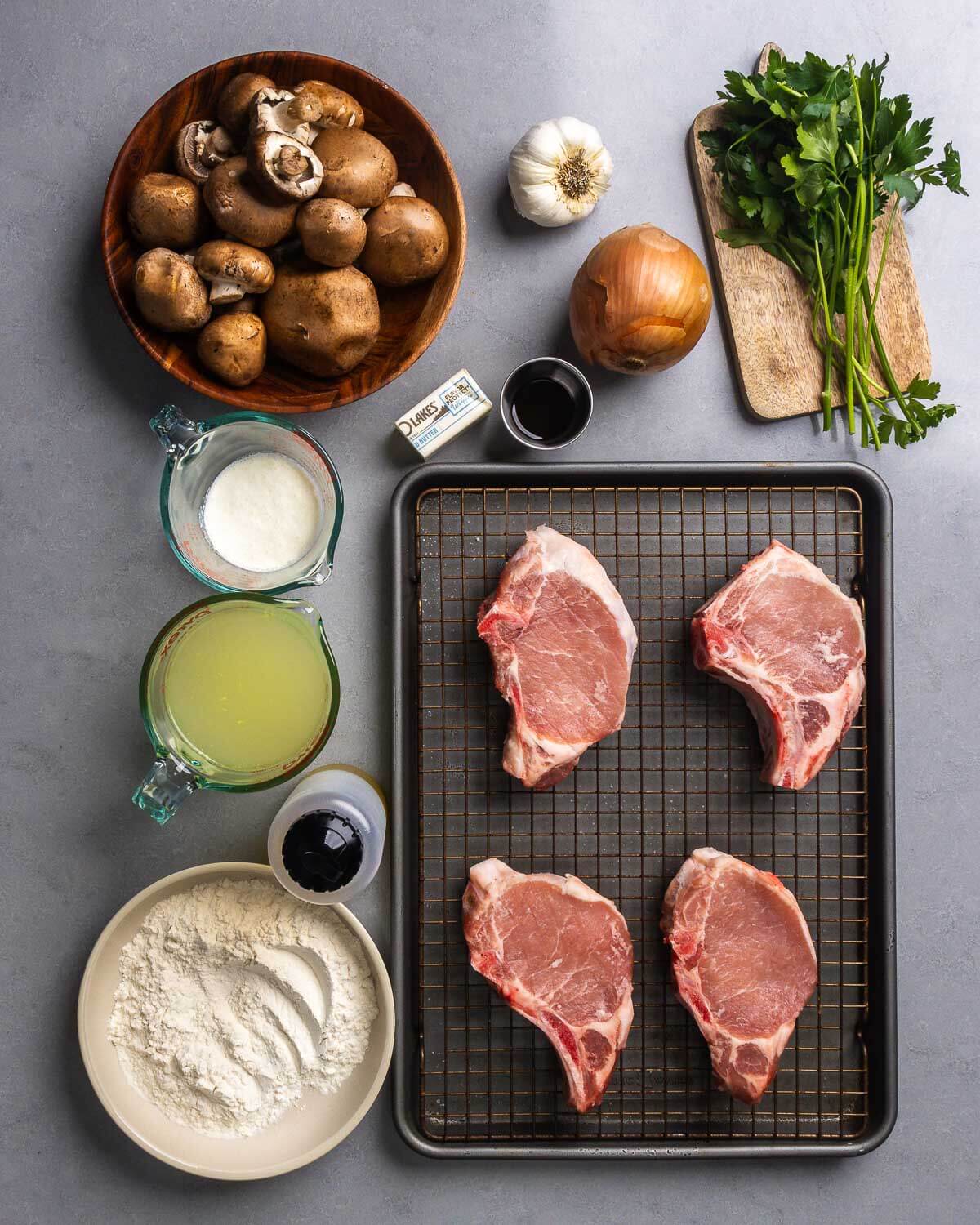 Ingredients shown: mushrooms, garlic, butter, worcestershire sauce, onion, parsley, cream, chicken stock, olive oil, flour, and pork chops.