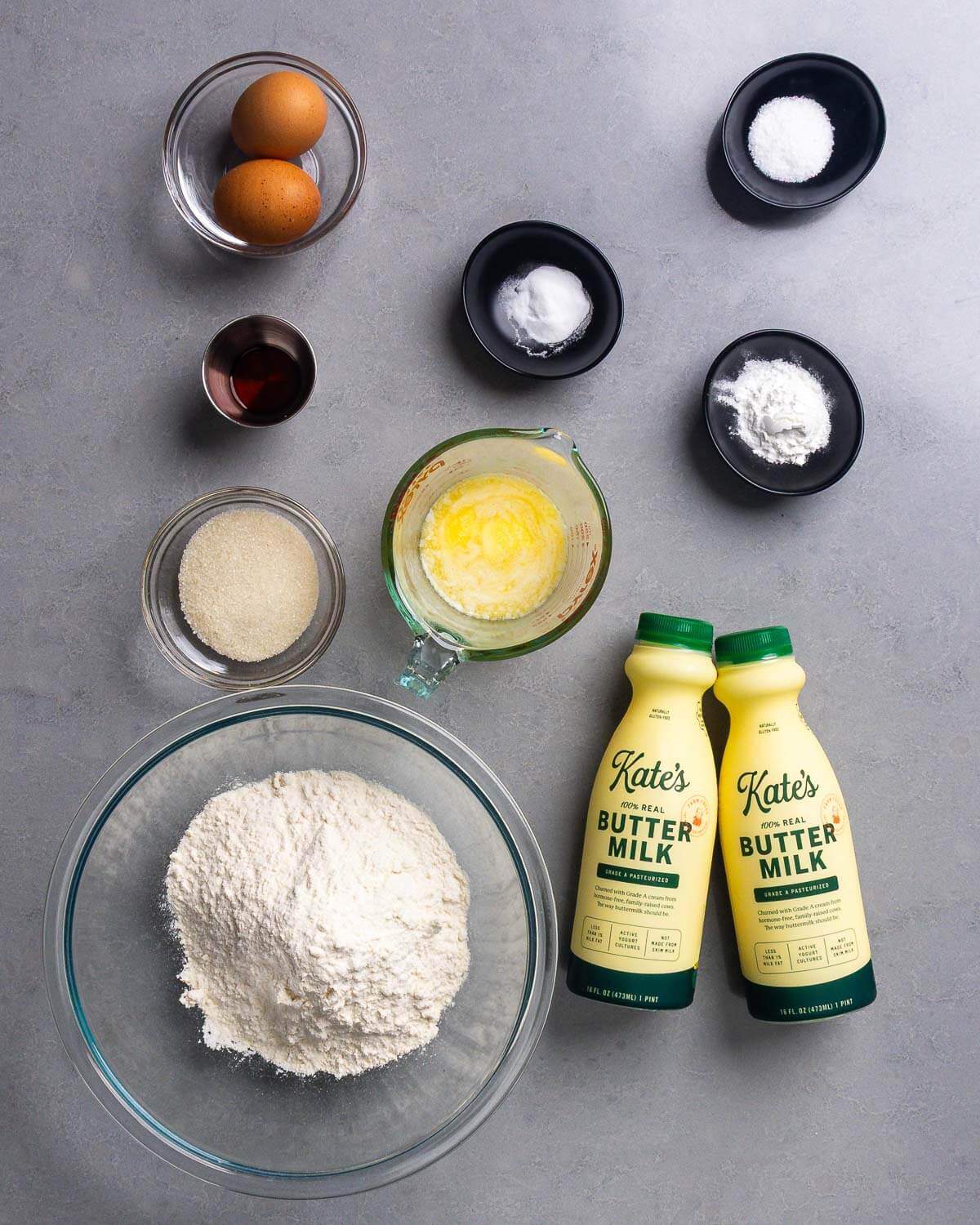 Ingredients shown: eggs, baking soda, baking powder, vanilla, salt, sugar, melted butter, all-purpose flour, and buttermilk.