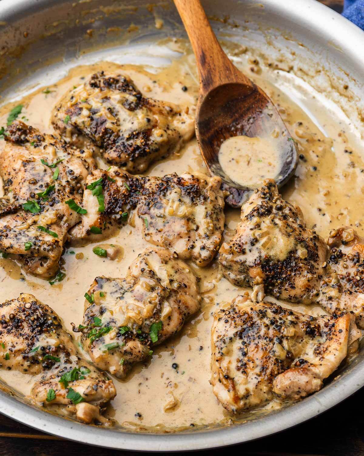 Large stainless pan with chicken au poivre.