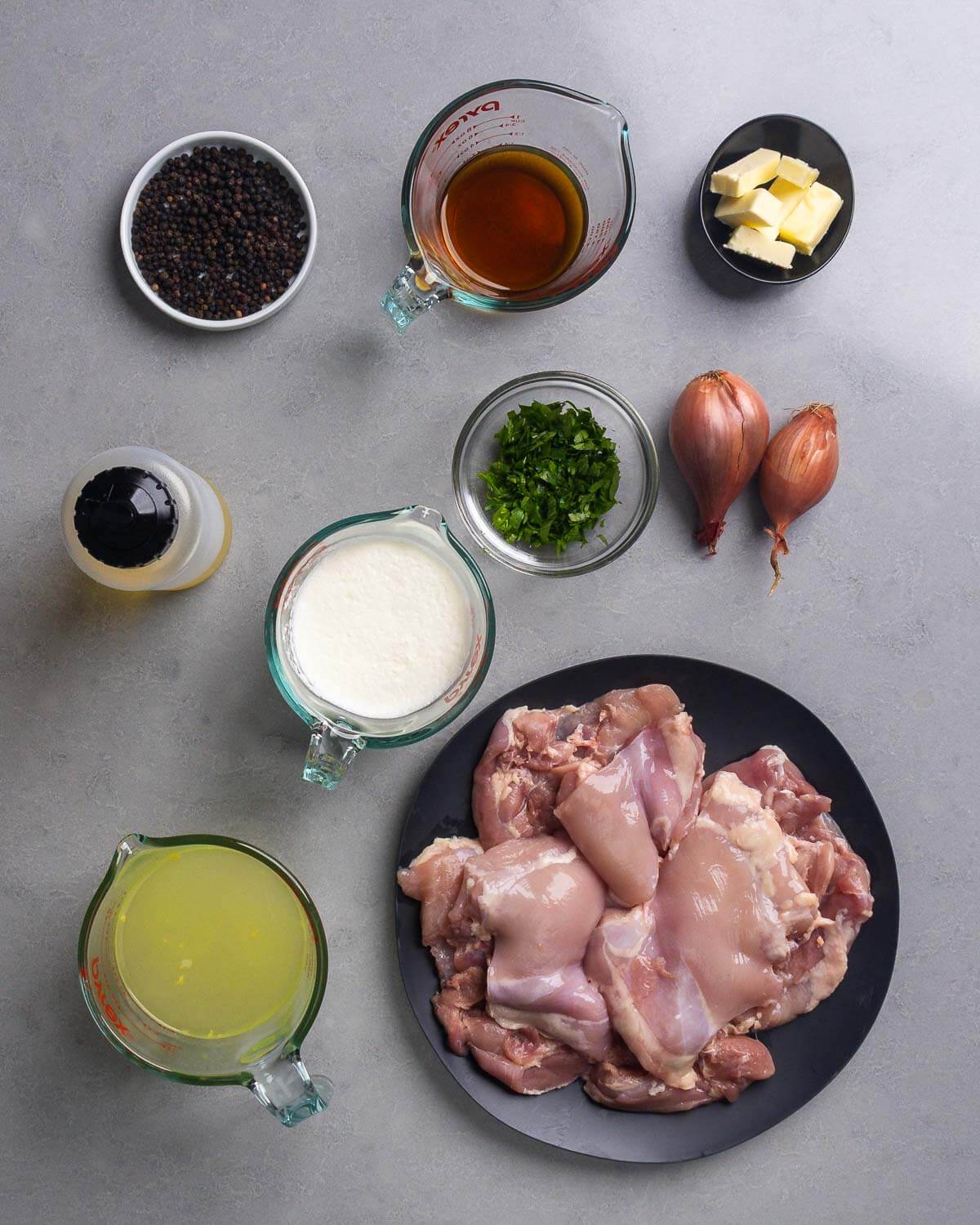 Ingredients shown: peppercorns, cognac, cold butter, olive oil, heavy cream, parsley, shallots, chicken stock, and boneless skinless chicken thighs.