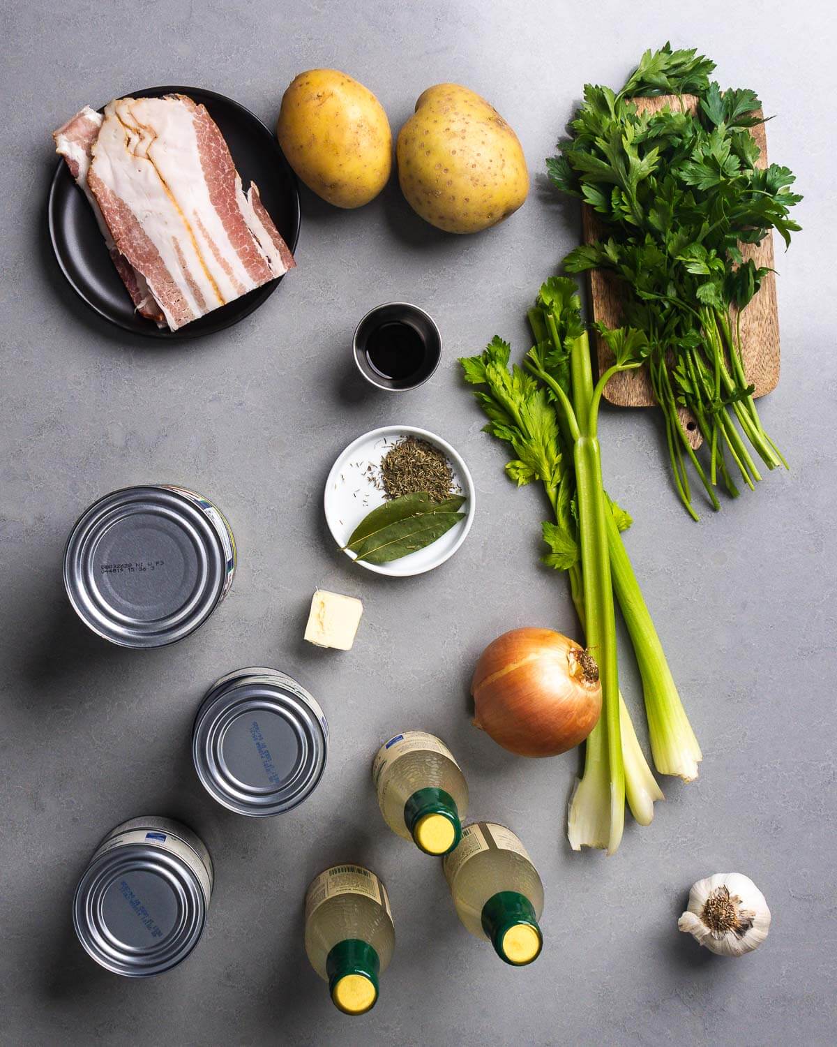 Ingredients shown: bacon, potatoes, worcestershire sauce, parsley, celery, canned tomatoes, butter, thyme, bay leaves, onion, canned clams, clam juice, and garlic.