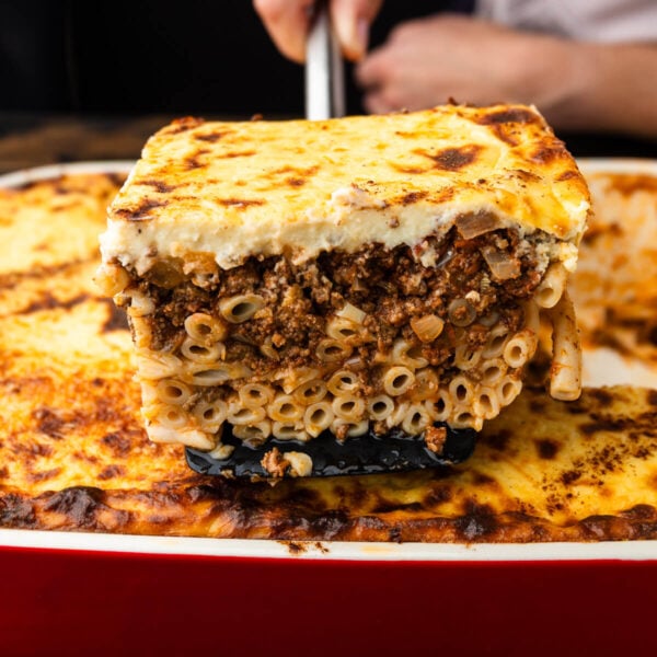 Large piece of pastitsio held with spatula.