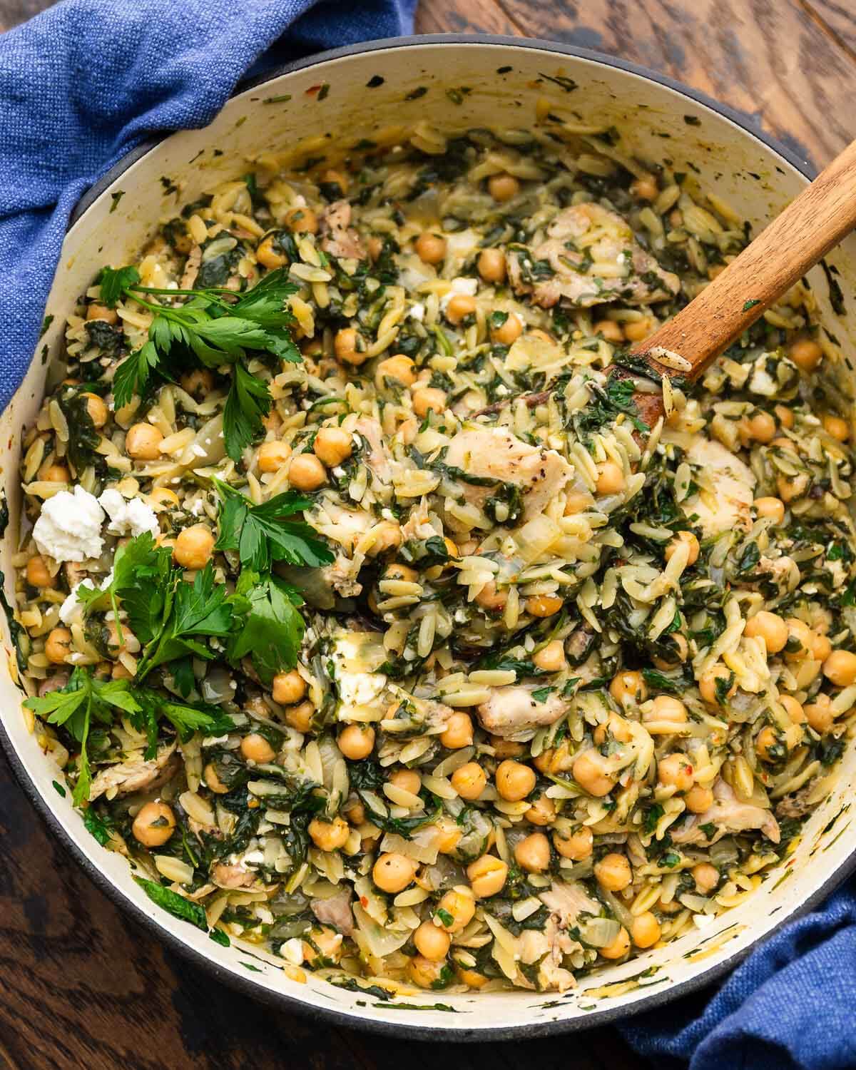 Large pot with spinach chicken orzo with chickpeas, feta, and lemon.