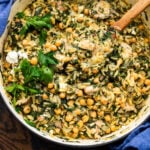 Large pot with spinach chicken orzo topped with fresh parsley.